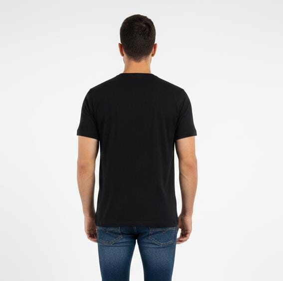 Back view of man wearing black men’s t-shirt, plain design with no print, short sleeves on plain background
