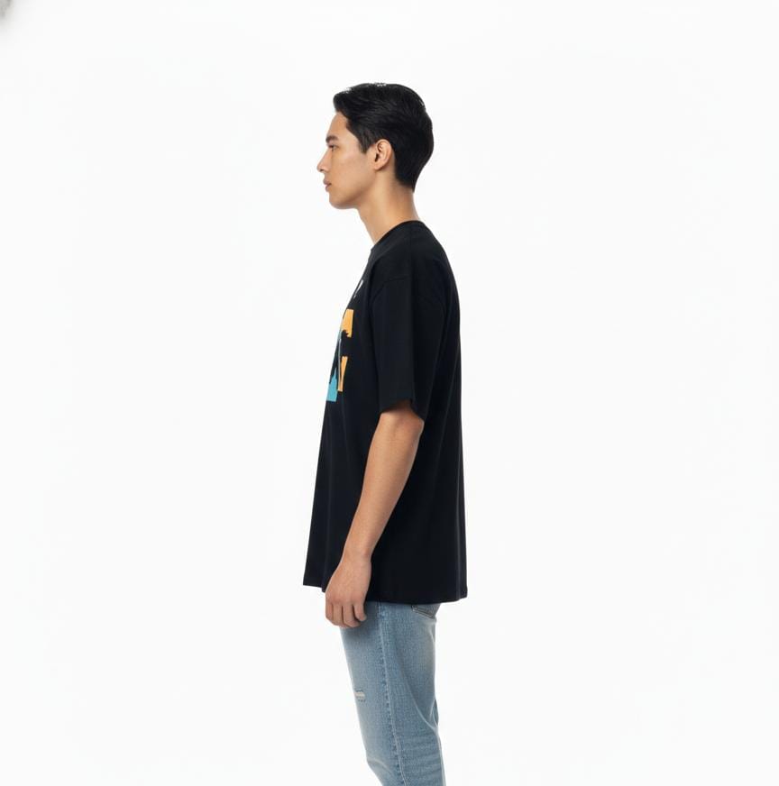 Side angle view of black oversized streetwear superhero T-shirt for men