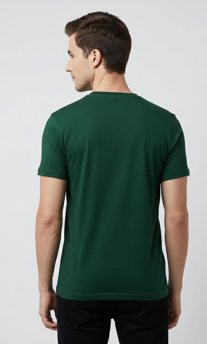 Back view of man wearing dark green men’s t-shirt, plain design with no print, short sleeves on plain background
