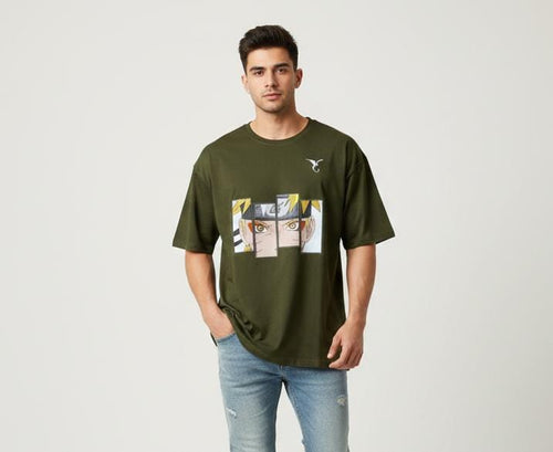 Man wearing olive green oversized t-shirt with anime graphic print on front, casual streetwear style on plain background
