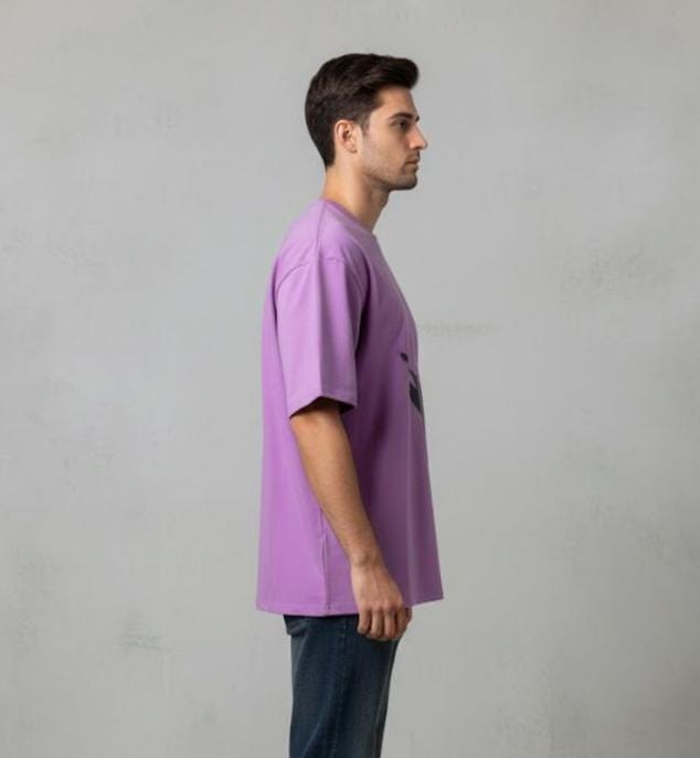 Side view of man wearing purple oversized men’s t-shirt with short sleeves, relaxed casual fit on neutral background

