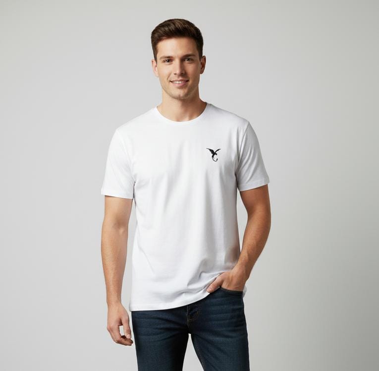 Man wearing white men’s t-shirt with minimal chest logo, short sleeves, regular fit on plain background
